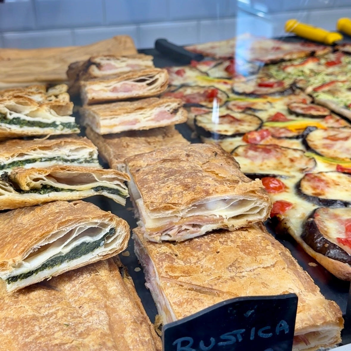 Display case of gluten free pizza and sandwiches 